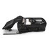 Open black travel bag packed with clothes and headphones.