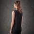 A woman wearing a black sleeveless tank top, viewed from the back, against a textured grey background.