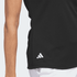 A black polo shirt featuring a logo, designed for women's activewear with a fitted silhouette.
