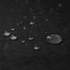 A close-up of water droplets on a textured black surface, showcasing various sizes and reflections.