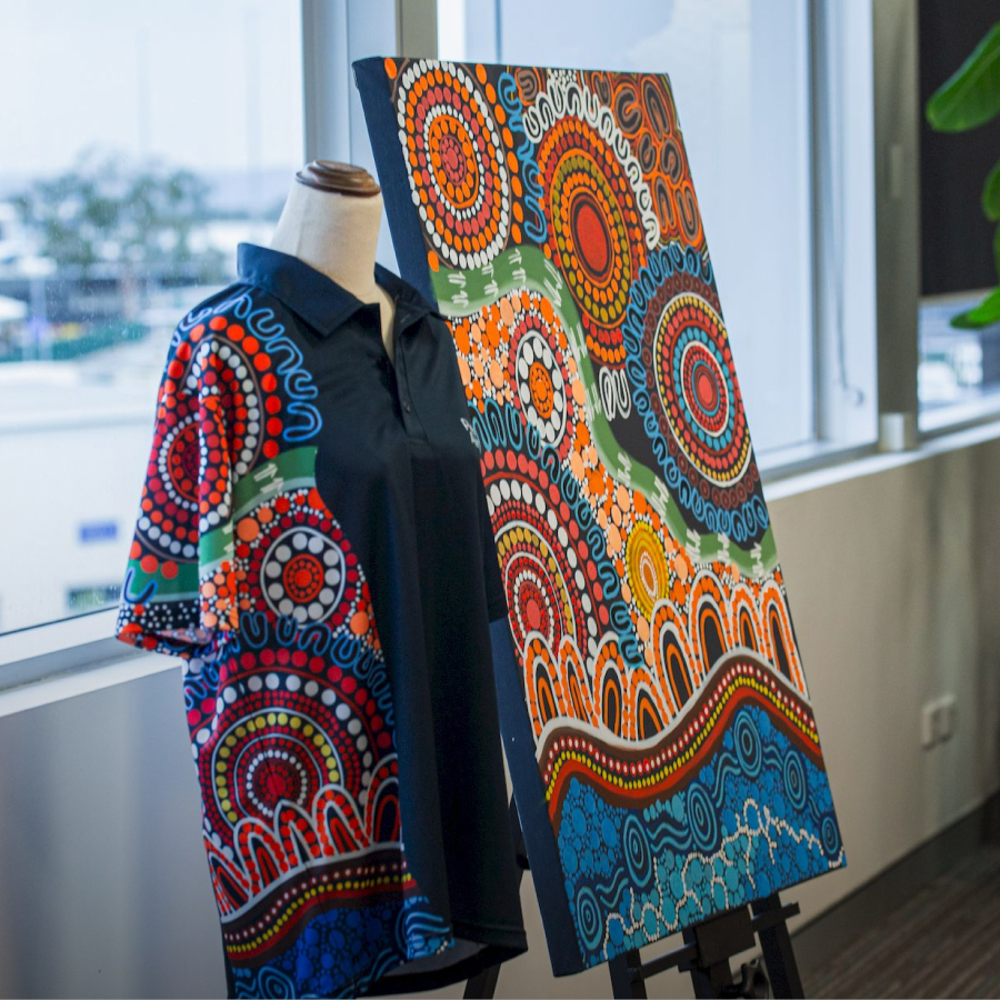 Mannequin wearing a shirt with vibrant Indigenous art pattern