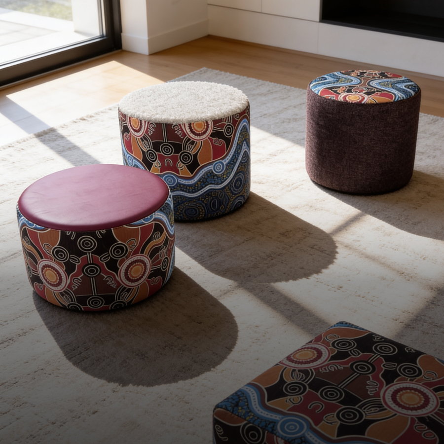 A colorful Aboriginal-style artwork is printed on a gray modular sofa.