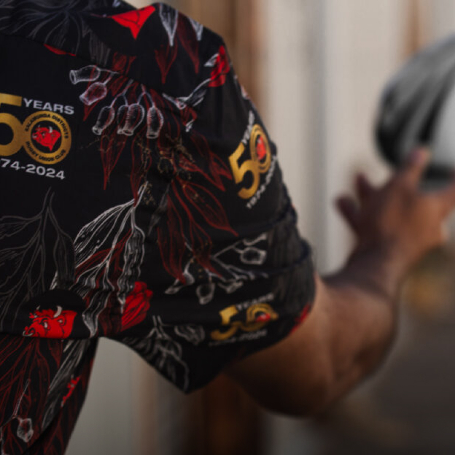 A colorful embroidered logo on the chest, featuring an abstract landscape design.