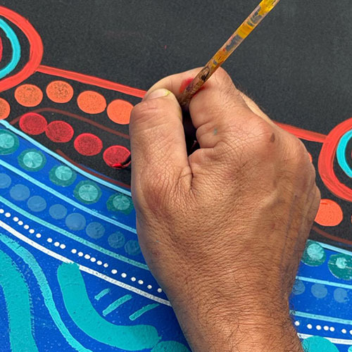 A close-up of Kevin Bynder working on artwork in the office
