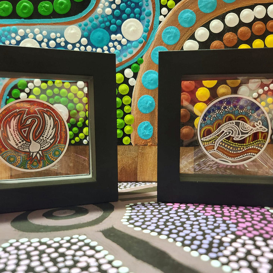 Framed Aboriginal art with colourful dot patterns, the left frame shows a stylised bird, the right frame depicts a kangaroo