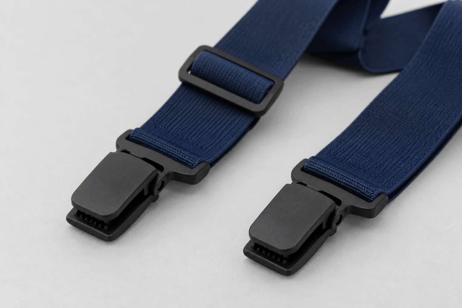 Close-up of no-metal plastic suspender clips and plastic adjusters for airport security