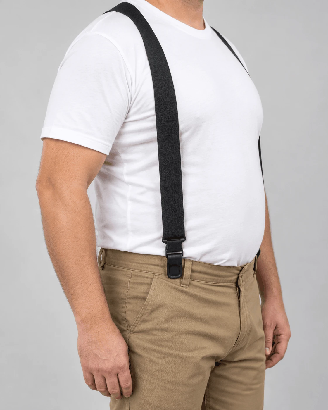 Big and tall man wearing side clip suspenders attached at the hips of his pants