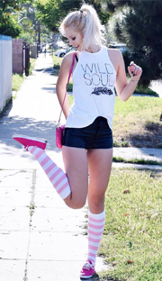 black shorts, small purse, pink striped socks