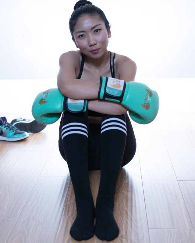 woman boxer with boxing gloves and knee highs