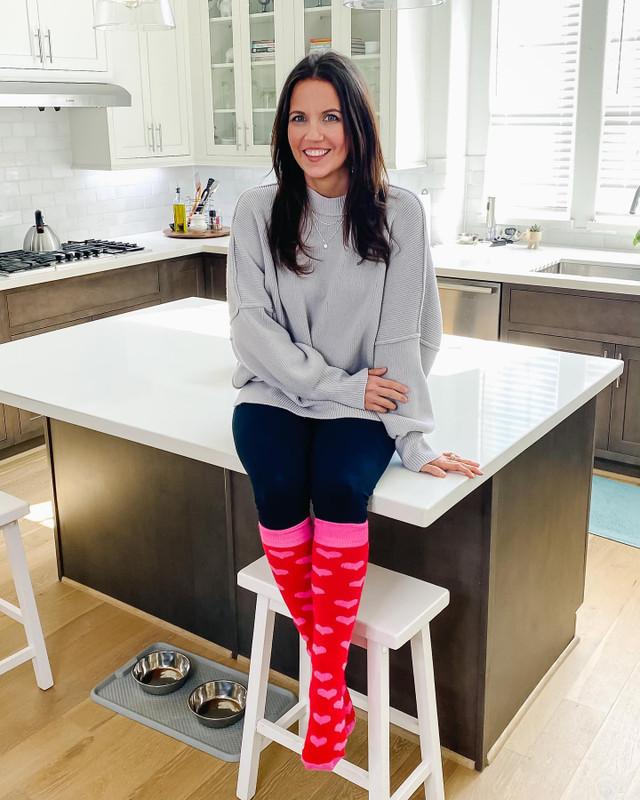 sitting on kitchen island with colorful heart socks