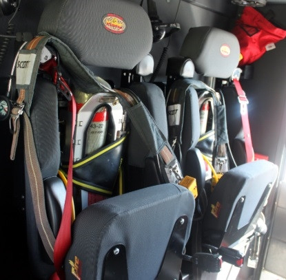 Fire apparatus SCBA storage using Zico EZ-Out bracket with spring