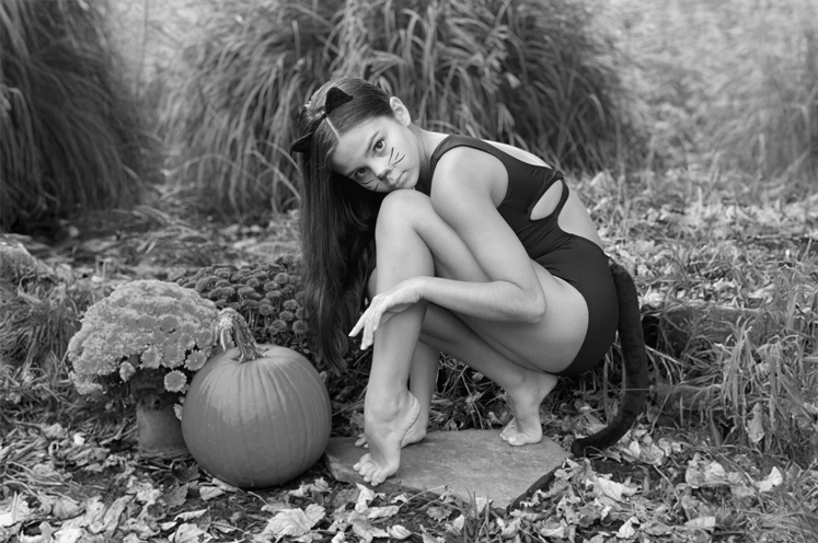 Dancer posing on a dock in front of a lake wearing FORM style  20913 in wine