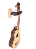 Hercules USP10WB Ukulele Hanger with Wood Base featuring a wooden mounting plate, foam-padded yoke arms, and universal compatibility for all ukulele sizes.