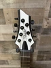 Schecter C-7 Contrasts Rob Scallon 7-String Multiscale guitar featuring a dual white/black finish, multi-scale ebony fingerboard, signature pickups, lightweight body, and signature Rob Scallon design elements.