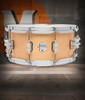 PDP Concept Maple 6.5x14 Snare Drum in Natural Lacquer finish with maple shell and chrome hardware, offering warm tone and timeless appeal.