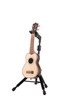 Hercules UKS100B Auto Grip Ukulele Stand featuring AGS automatic neck locking, padded support arms, and a stable foldable frame compatible with all ukulele sizes.