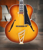 The Dâ€™Angelico DAESTBDITBGT Archtop Hollow Body Guitar features a beautifully sculpted body with carved-style archtop construction, delivering warm, resonant tone ideal for jazz, blues, and classic styles. Its Dark Iced Tea Burst finish highlights the elegant vintage aesthetic, while the comfortable neck and quality electronics provide smooth playability and rich amplified sound. A sophisticated instrument built with Dâ€™Angelicoâ€™s timeless craftsmanship.