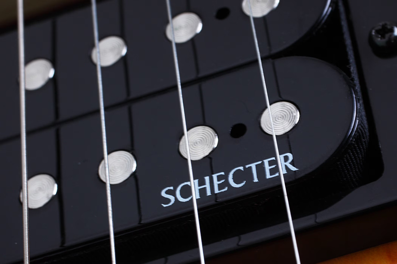 Schecter Omen Extreme-6 String Electric Guitar with quilted maple top, dual humbuckers, and contoured body design in gloss finish.