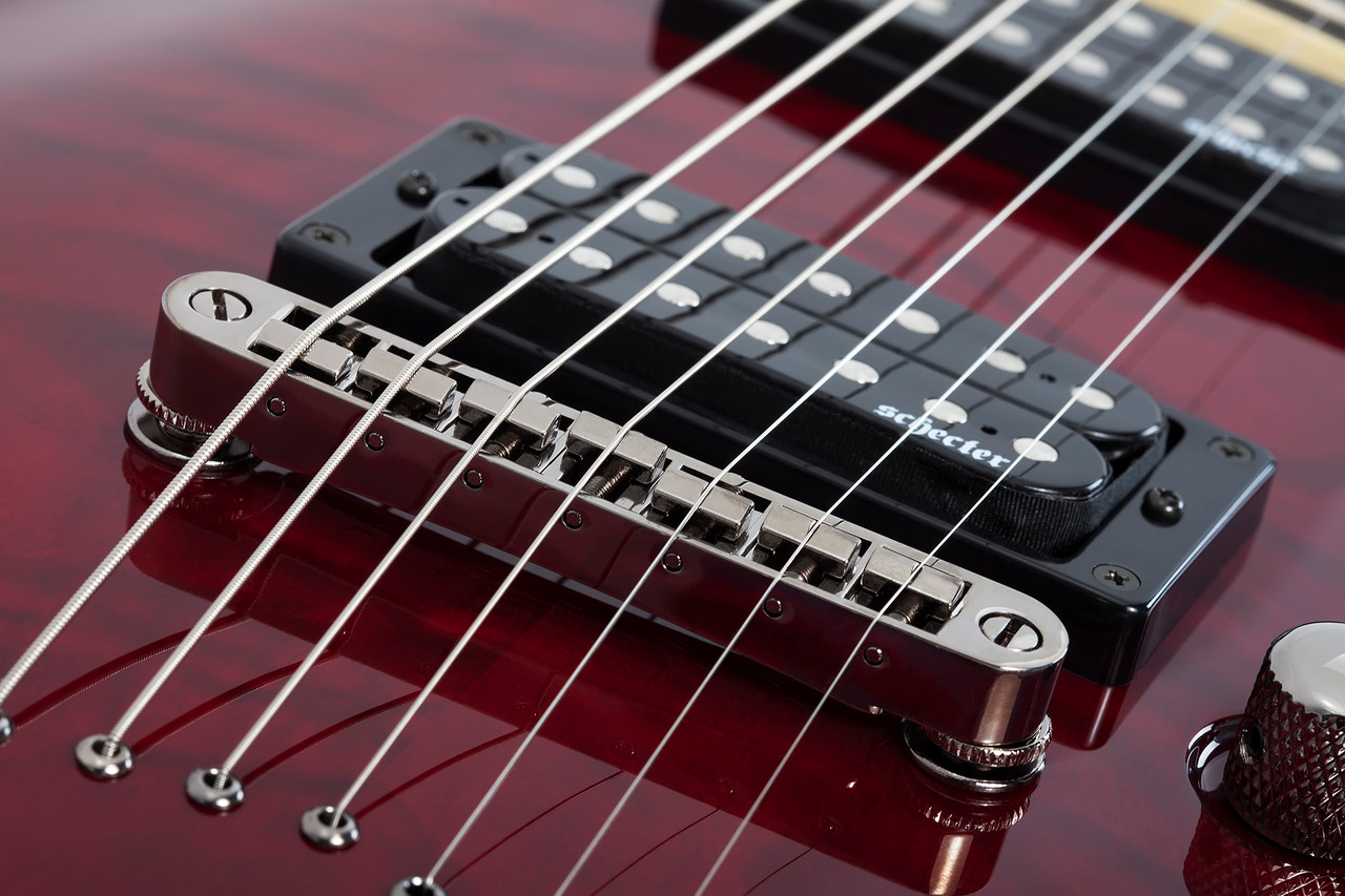 The Schecter Omen Extreme-7 String Electric Guitar (Item #2008) features a stunning Black Cherry quilted maple top over a mahogany body, delivering rich resonance and aggressive bite. Its thin-C maple neck and rosewood fingerboard provide fast, comfortable playability, while Schecter Diamond Plus humbuckers deliver high-output tone suited for metal, rock, and modern extended-range styles. Additional features include black chrome hardware, Tune-O-Matic bridge, and sleek multi-ply binding.