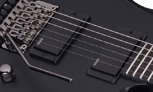 Schecter Tommy Victor Devil FR Electric Guitar with arched mahogany body, dual humbuckers, and Floyd Rose tremolo system in gloss black finish.