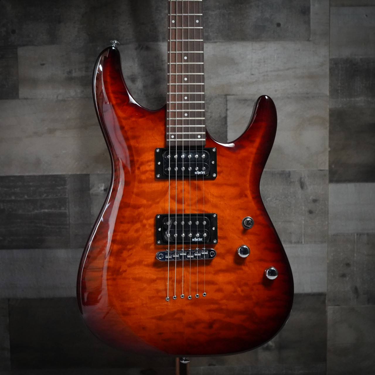 The Schecter C-6 Plus in Vintage Sunburst (444) offers classic styling with its quilted maple top and warm burst finish. Equipped with high-output humbuckers and a smooth thin-C neck, it delivers powerful tone and comfortable playability for rock, metal, blues, and everyday practice. A great choice for players seeking Schecter quality at an accessible price.