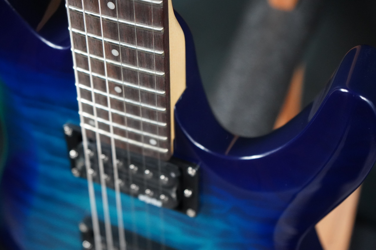 The Schecter C-6 Plus in Ocean Blue Burst (443) features a beautiful quilted maple top with an eye-catching burst finish. Equipped with a thin-C maple neck, high-output humbuckers, and a comfortable contoured body, it delivers strong tone and smooth playability. A great choice for rock, metal, and versatile everyday electric guitar performance.