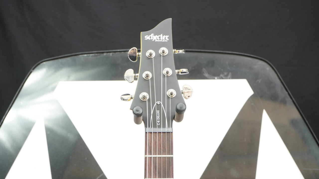 Schecter C-6 Deluxe Electric Guitar - Satin Black (B-Stock) featuring sleek satin finish, dual humbuckers, lightweight basswood body, and fast maple neck for versatile modern tone