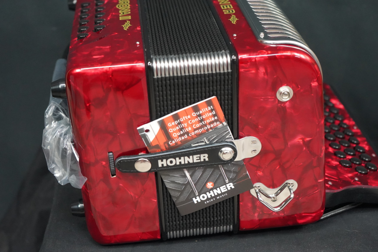 The Hohner Corona II XTREME FBbEb diatonic accordion in pearl red (CXFR) delivers powerful projection and fast response, ideal for norteÃ±o and conjunto styles. Available at Musician Madness.