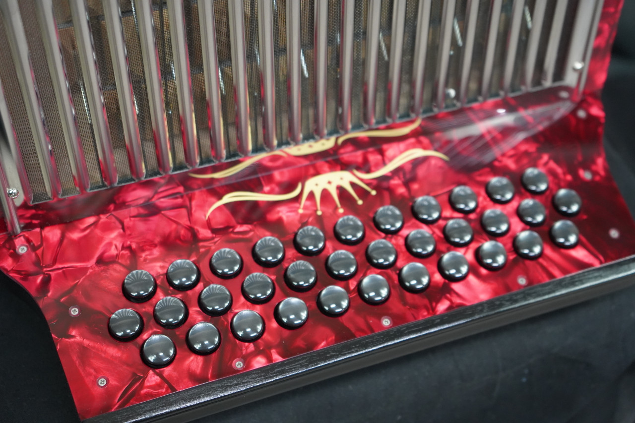 The Hohner Corona II XTREME FBbEb diatonic accordion in pearl red (CXFR) delivers powerful projection and fast response, ideal for norteÃƒÂ±o and conjunto styles. Available at Musician Madness.