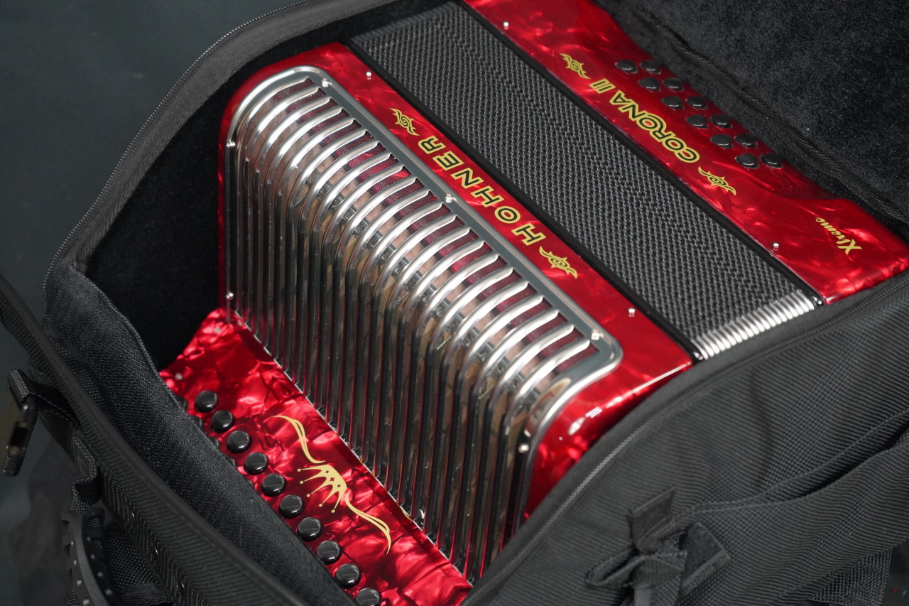 The Hohner Corona II XTREME FBbEb diatonic accordion in pearl red (CXFR) delivers powerful projection and fast response, ideal for norteÃƒÂ±o and conjunto styles. Available at Musician Madness.