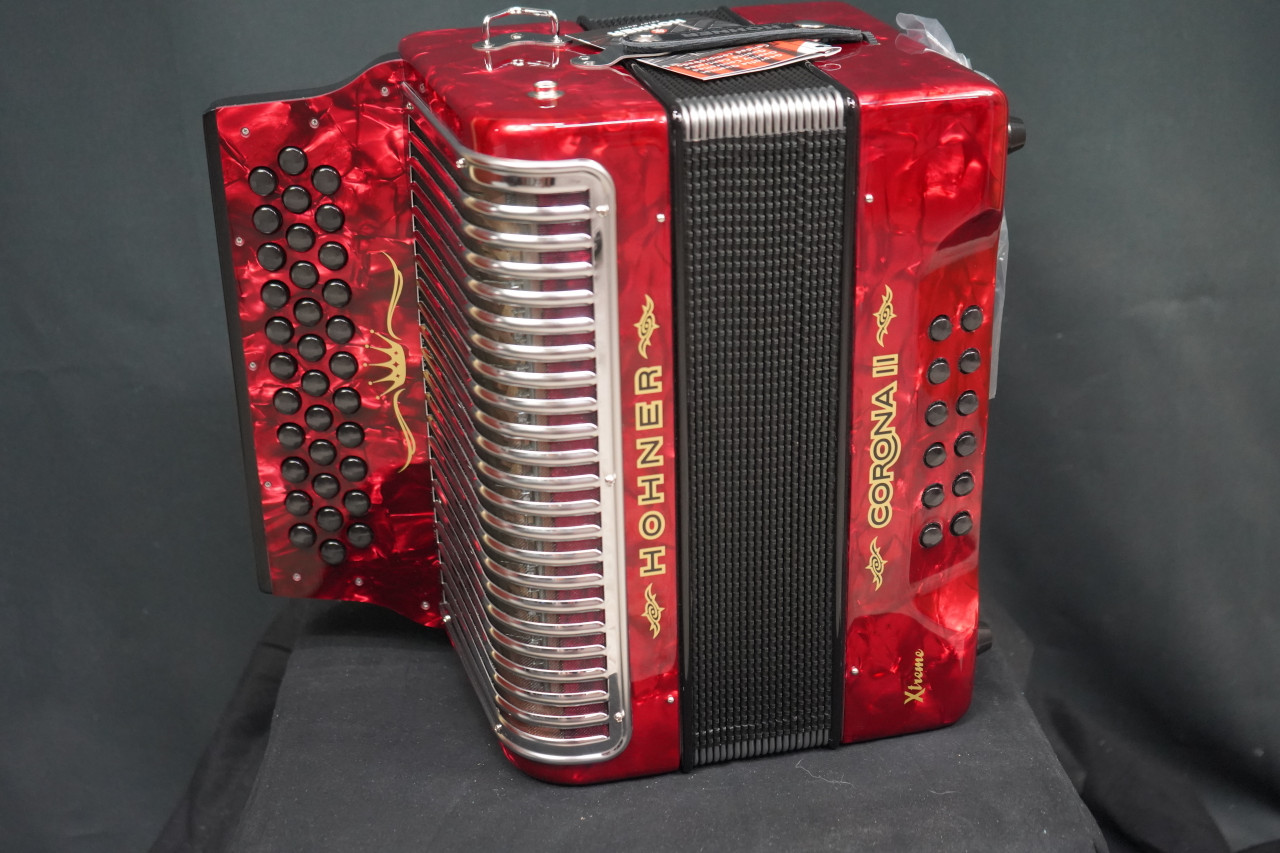 The Hohner Corona II XTREME FBbEb diatonic accordion in pearl red (CXFR) delivers powerful projection and fast response, ideal for norteÃƒÂ±o and conjunto styles. Available at Musician Madness.