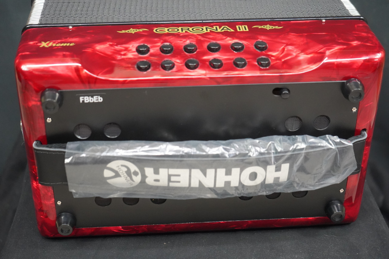 The Hohner Corona II XTREME FBbEb diatonic accordion in pearl red (CXFR) delivers powerful projection and fast response, ideal for norteÃ±o and conjunto styles. Available at Musician Madness.