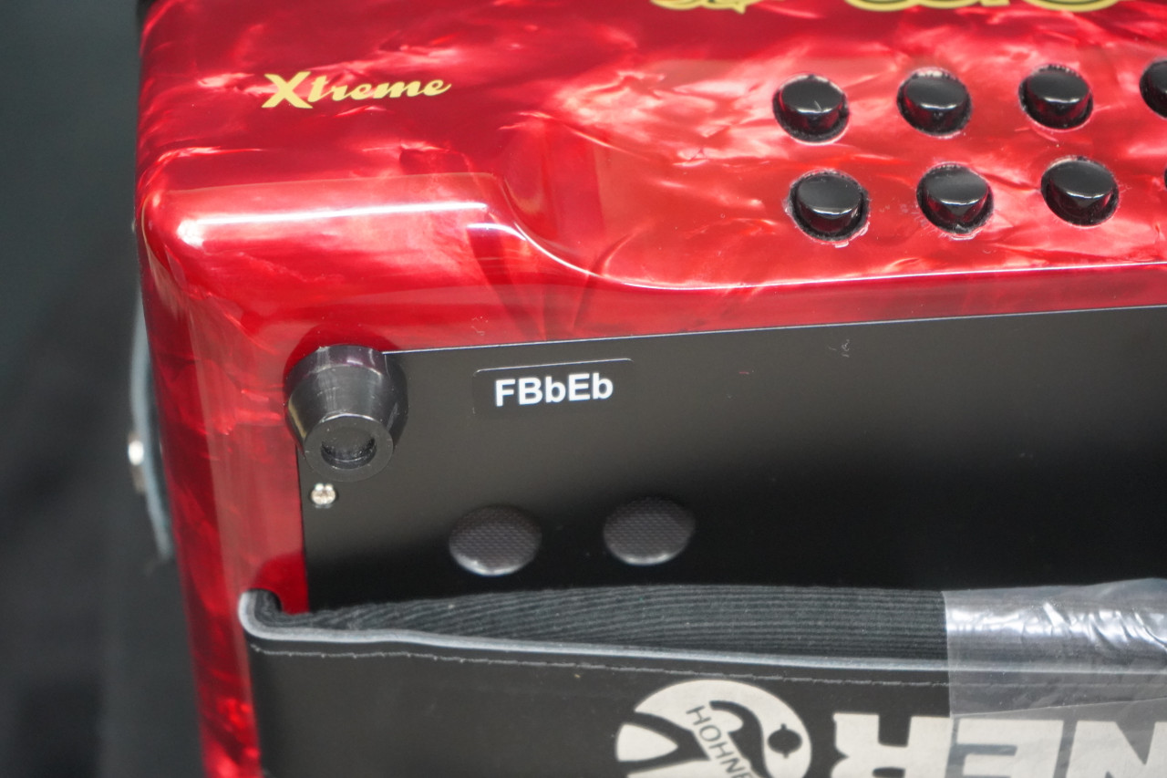 The Hohner Corona II XTREME FBbEb diatonic accordion in pearl red (CXFR) delivers powerful projection and fast response, ideal for norteÃƒÂ±o and conjunto styles. Available at Musician Madness.