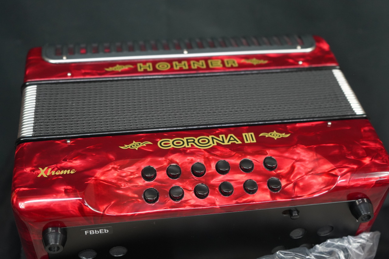 The Hohner Corona II XTREME FBbEb diatonic accordion in pearl red (CXFR) delivers powerful projection and fast response, ideal for norteÃ±o and conjunto styles. Available at Musician Madness.