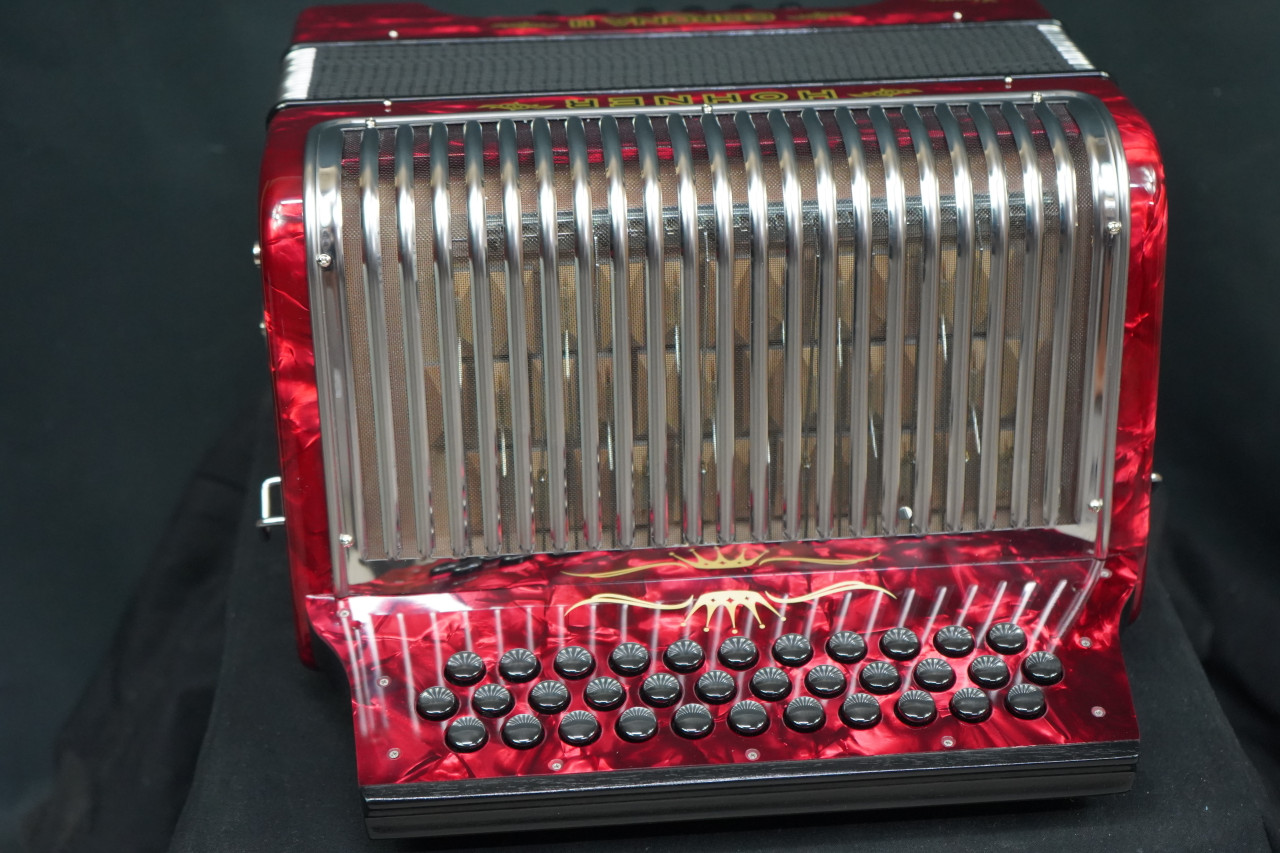 The Hohner Corona II XTREME FBbEb diatonic accordion in pearl red (CXFR) delivers powerful projection and fast response, ideal for norteÃƒÂ±o and conjunto styles. Available at Musician Madness.