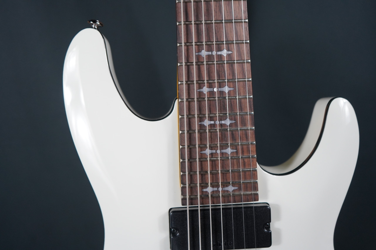 Schecter Demon-7 Electric Guitar - Vintage White (B-Stock) 7-string guitar with Schecter Diamond Active pickups, arched top body, black hardware, and smooth extended-range tone