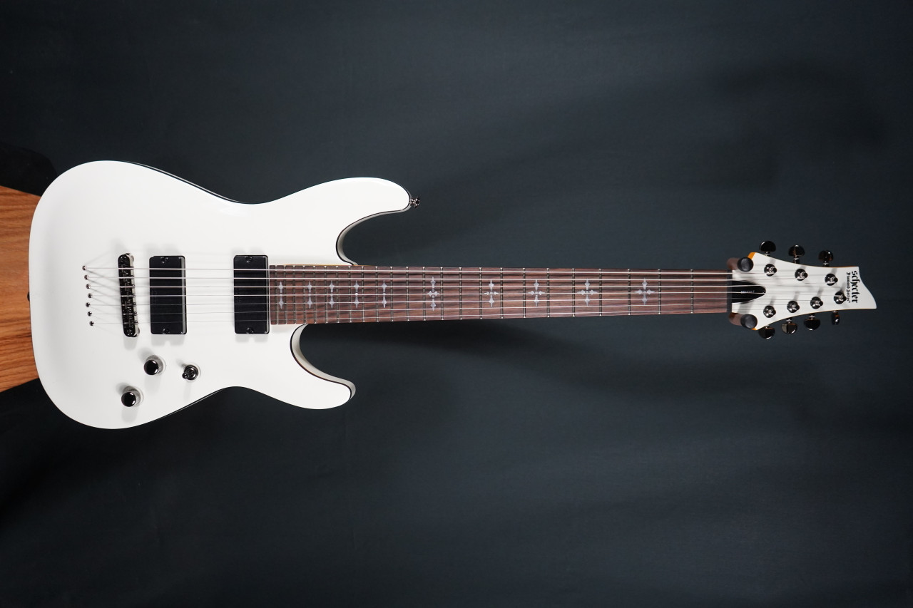 Schecter Demon-7 Electric Guitar - Vintage White (B-Stock) 7-string guitar with Schecter Diamond Active pickups, arched top body, black hardware, and smooth extended-range tone