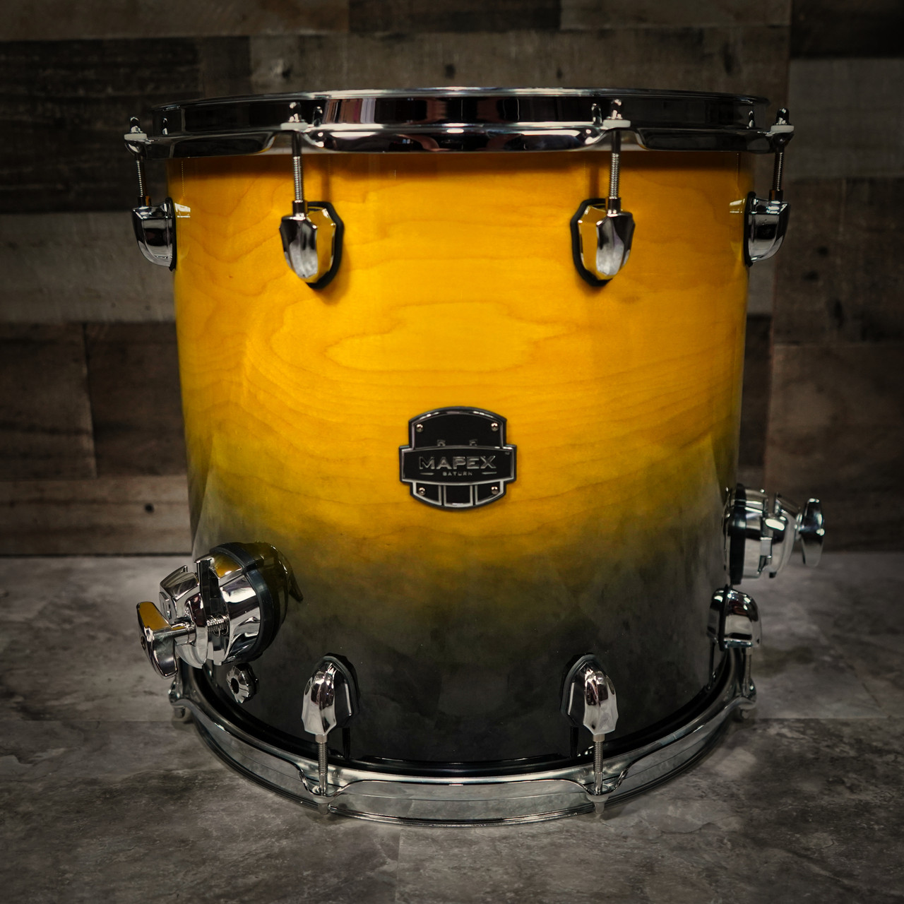 The Mapex Saturn SRF1414UJ 14x14 Floor Tom features hybrid maple/walnut shells that deliver deep low-end punch, rich mids, and articulate clarity. Finished in striking Sulphur Fade, it offers boutique aesthetics with professional performance. Ideal for drummers seeking premium tone, stability, and powerful projection for live or studio use.