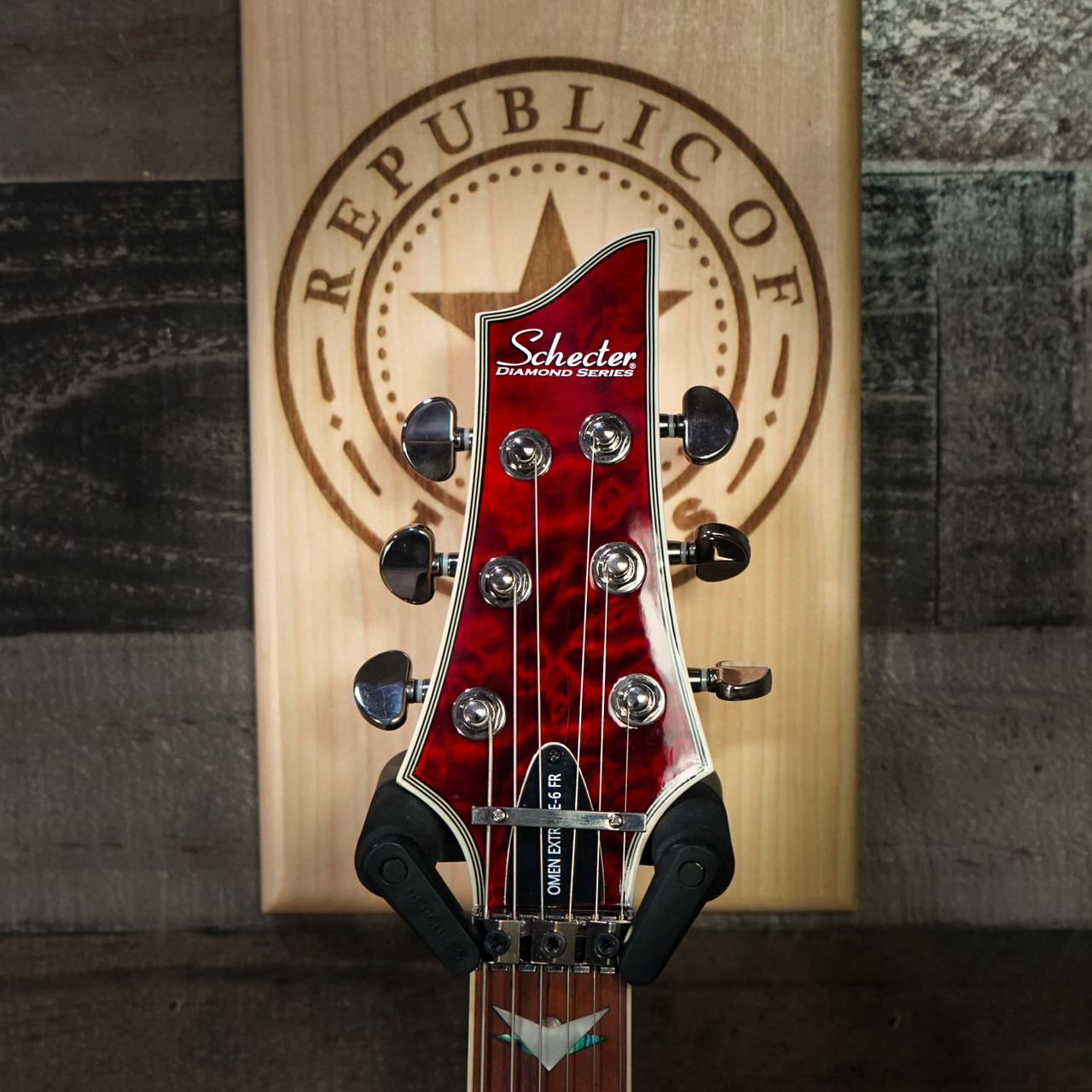 Schecter Omen Extreme-6 FR electric guitar in Black Cherry featuring a carved quilted maple top, dual high-output humbuckers, Floyd Rose tremolo system, rosewood fingerboard, and sleek modern hardware.