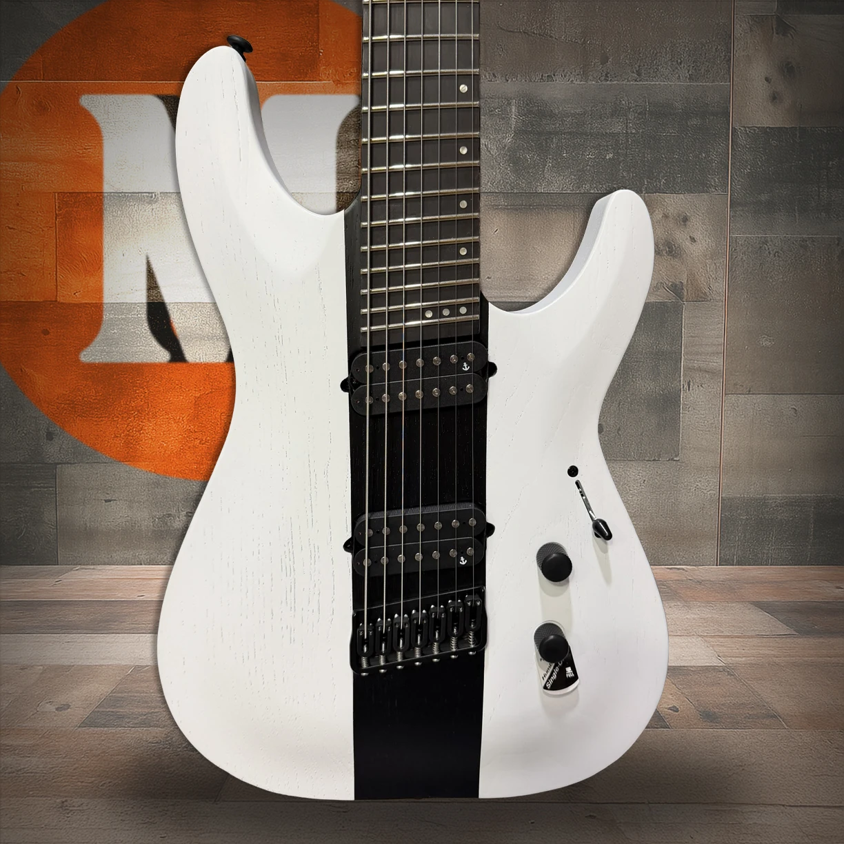Schecter C-7 Contrasts Rob Scallon 7-String Multiscale guitar featuring a dual white/black finish, multi-scale ebony fingerboard, signature pickups, lightweight body, and signature Rob Scallon design elements.