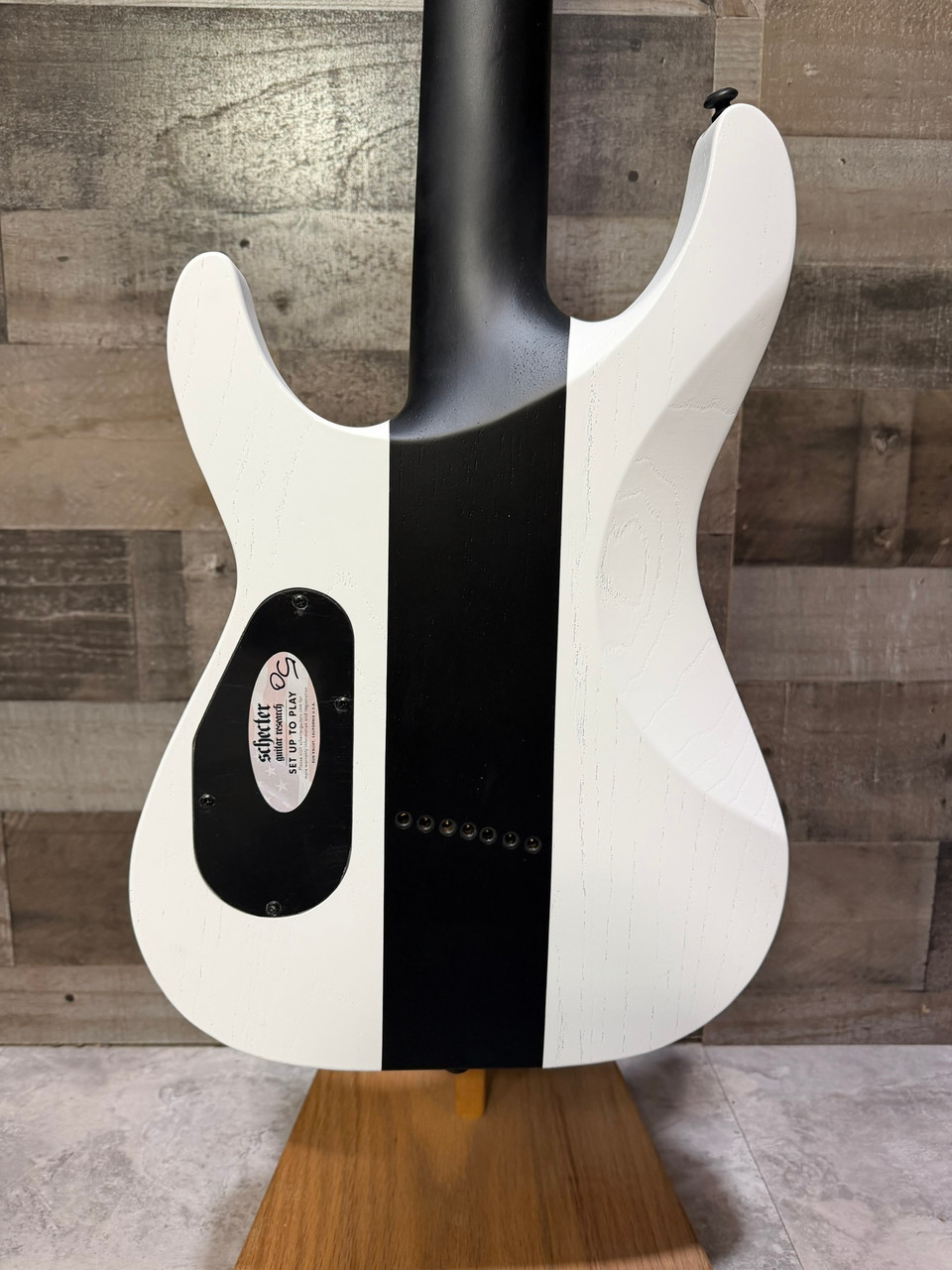 Schecter C-7 Contrasts Rob Scallon 7-String Multiscale guitar featuring a dual white/black finish, multi-scale ebony fingerboard, signature pickups, lightweight body, and signature Rob Scallon design elements.