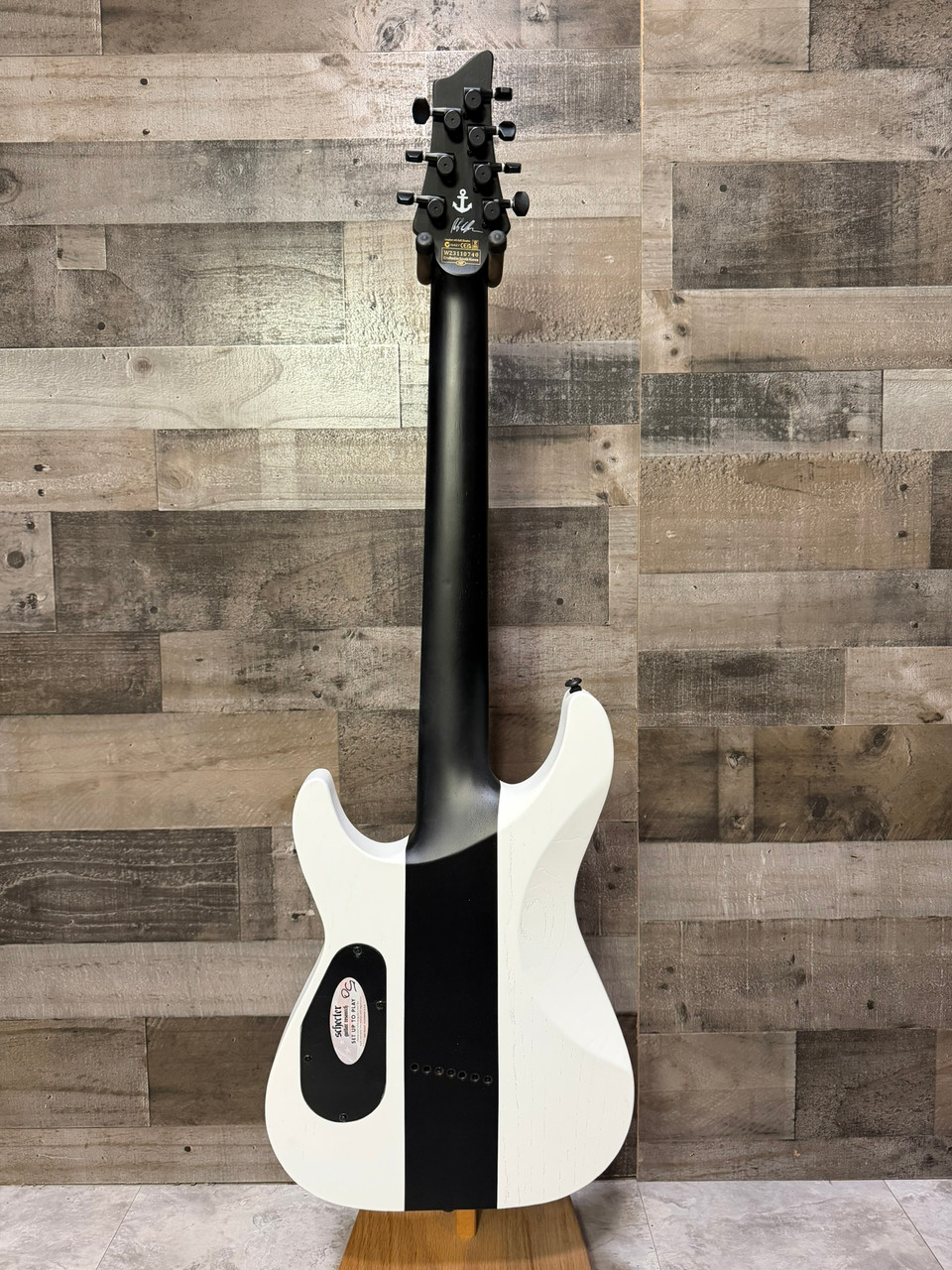 Schecter C-7 Contrasts Rob Scallon 7-String Multiscale guitar featuring a dual white/black finish, multi-scale ebony fingerboard, signature pickups, lightweight body, and signature Rob Scallon design elements.