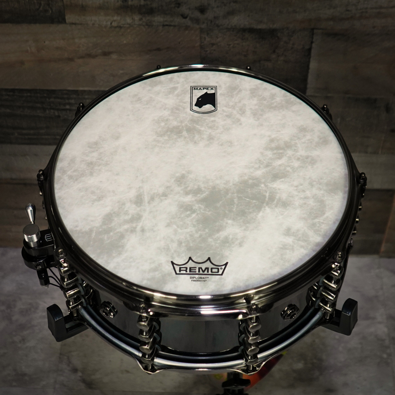 Mapex Black Panther Design Lab Maximus 14" x 6" Snare Drum â€“ Piano Black (BPDLMH4600LPB) featuring a mahogany shell, vintage tone, and glossy black finish for classic sound and style.