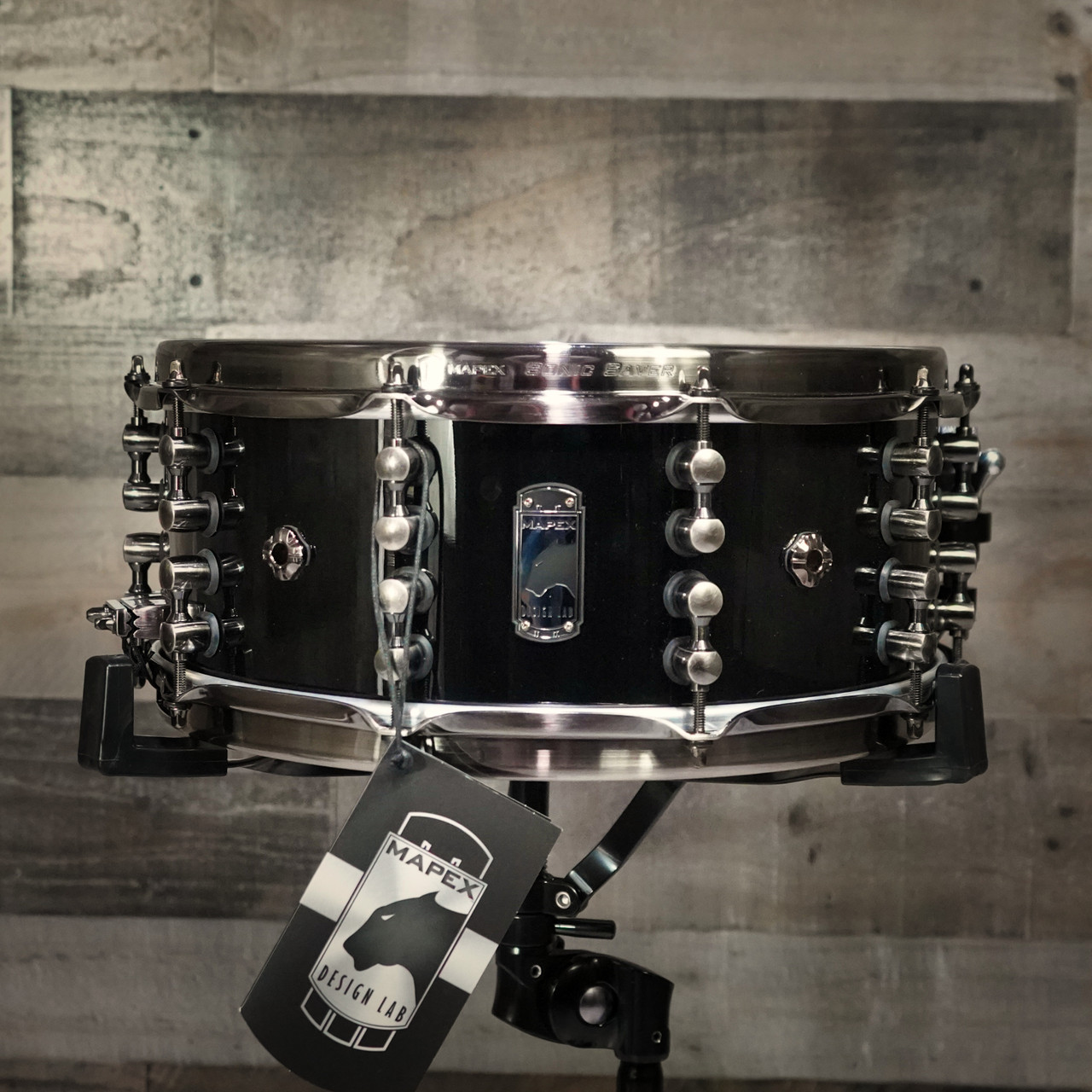 Mapex Black Panther Design Lab Maximus 14" x 6" Snare Drum â€“ Piano Black (BPDLMH4600LPB) featuring a mahogany shell, vintage tone, and glossy black finish for classic sound and style.