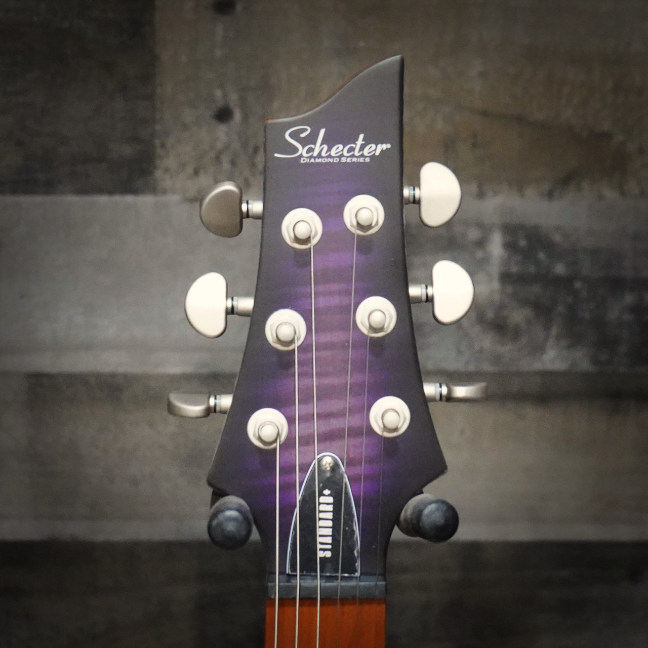 The Schecter C-1 Standard Plus (3935) showcases a striking quilted maple top under a Transparent Purple Burst finish, offering both eye-catching style and resonant tone. Equipped with Schecter Diamond Series humbuckers, a fast Thin-C neck, and dependable hardware, this guitar delivers powerful, articulate sound for rock, metal, and modern playing styles. A visually stunning and performance-ready instrument for players of all levels.