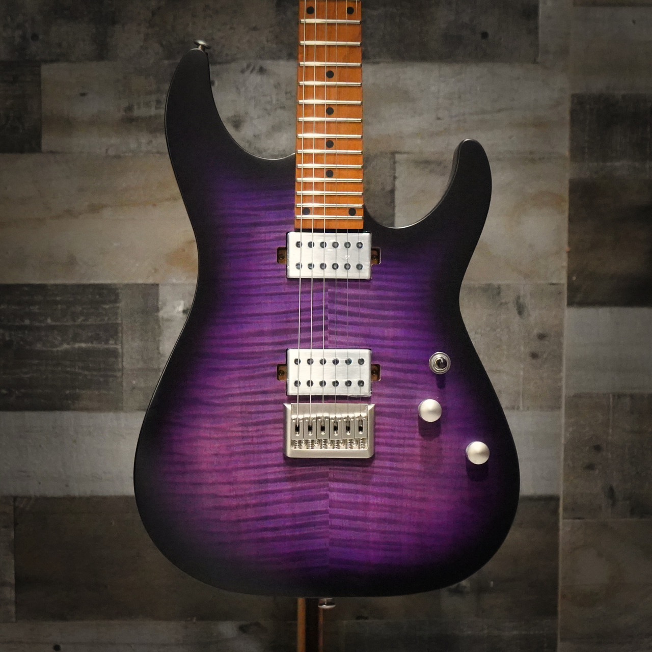 The Schecter C-1 Standard Plus (3935) showcases a striking quilted maple top under a Transparent Purple Burst finish, offering both eye-catching style and resonant tone. Equipped with Schecter Diamond Series humbuckers, a fast Thin-C neck, and dependable hardware, this guitar delivers powerful, articulate sound for rock, metal, and modern playing styles. A visually stunning and performance-ready instrument for players of all levels.