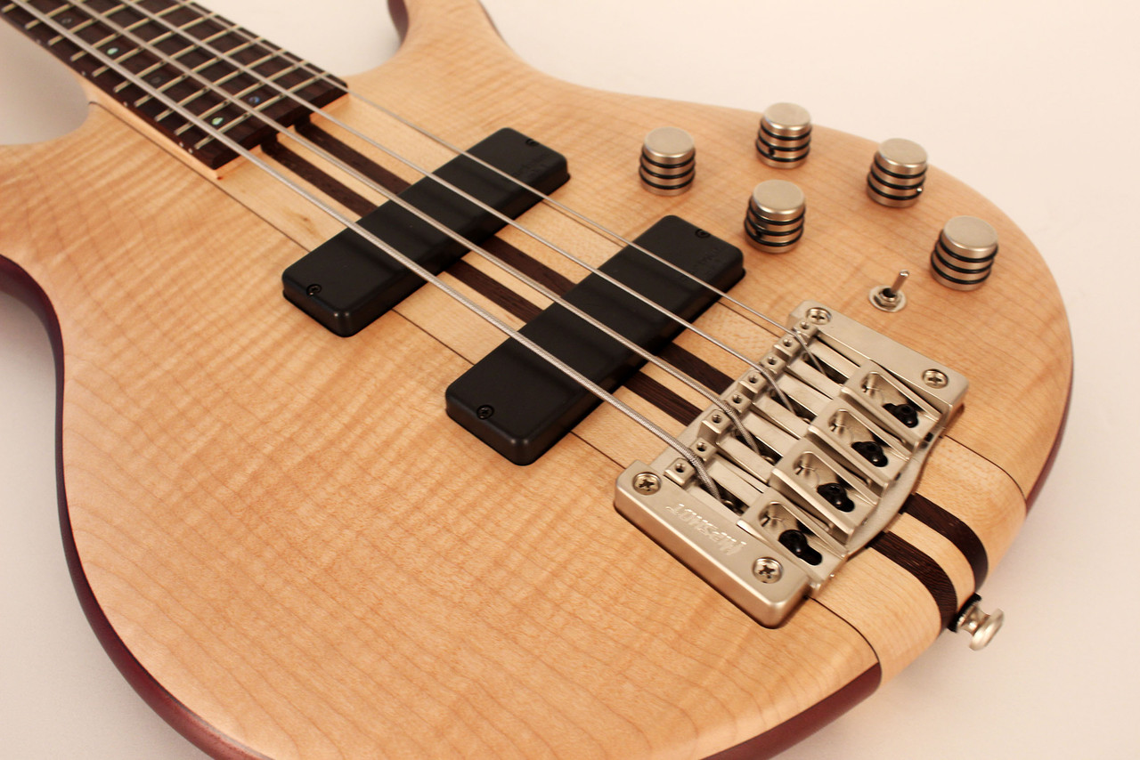 Cort A4PLUSFMMHOPN Artisan Series A4 Plus Bass Guitar in Open Pore Natural finish with flamed maple top and Bartolini MK-1 pickups.