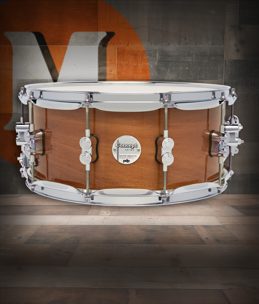 PDP Concept Maple Exotic 6.5x14 Snare Drum in Natural Honey Mahogany Lacquer finish with maple shell and chrome hardware, producing rich tone and striking exotic look.