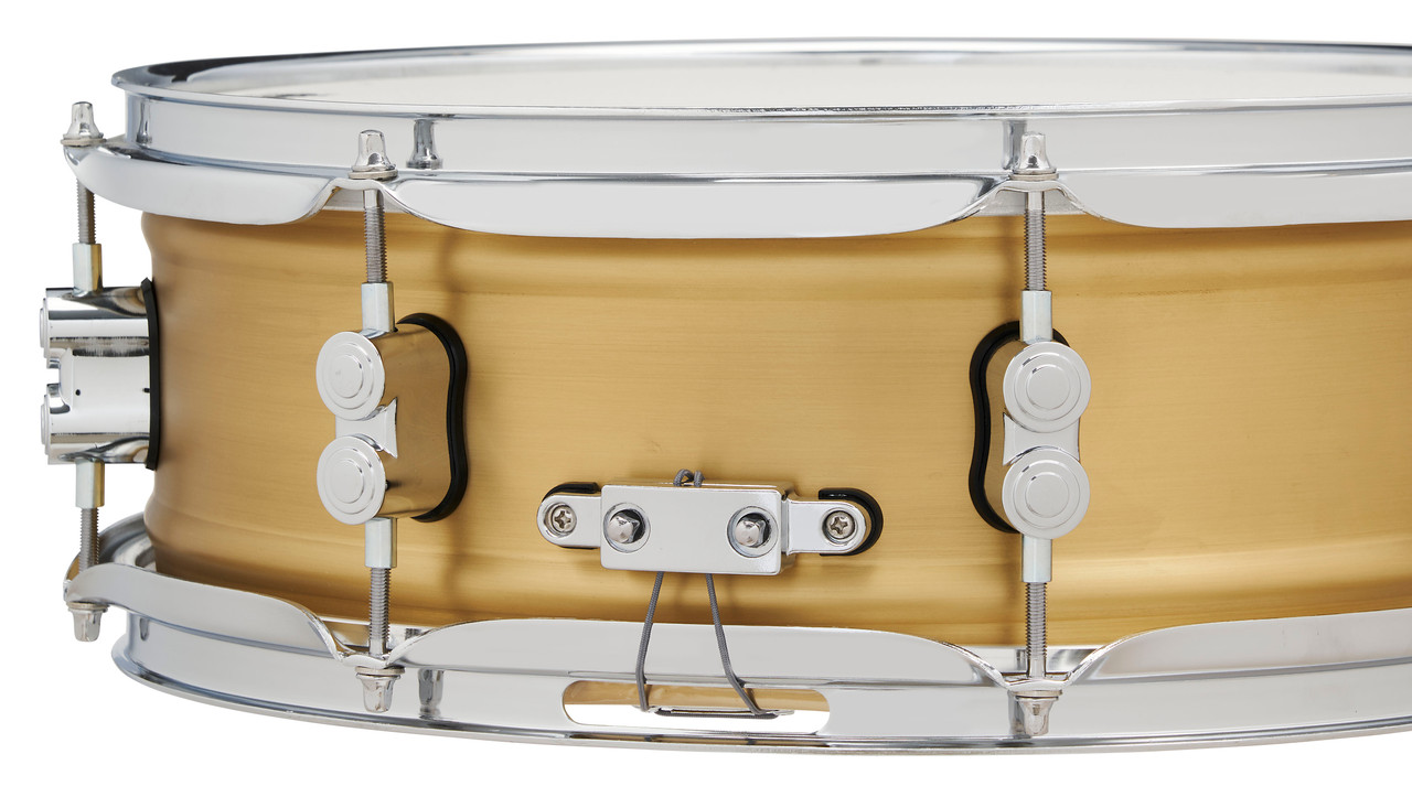 PDP Concept Series 5x14 Snare Drum in Natural Satin Brushed Brass with 1.2mm shell and chrome hardware, producing warm, punchy tone with elegant brushed finish.