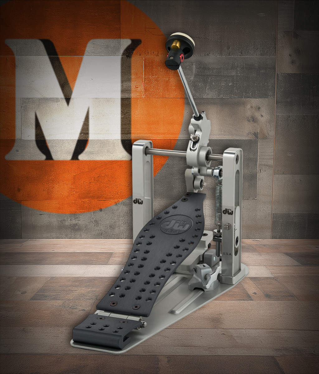 DW MFG Series Machined Direct Drive Single Pedal Gun Metal Edition with carry bag, featuring dark metallic gunmetal finish, precision-machined aluminum design, and smooth direct drive mechanism.